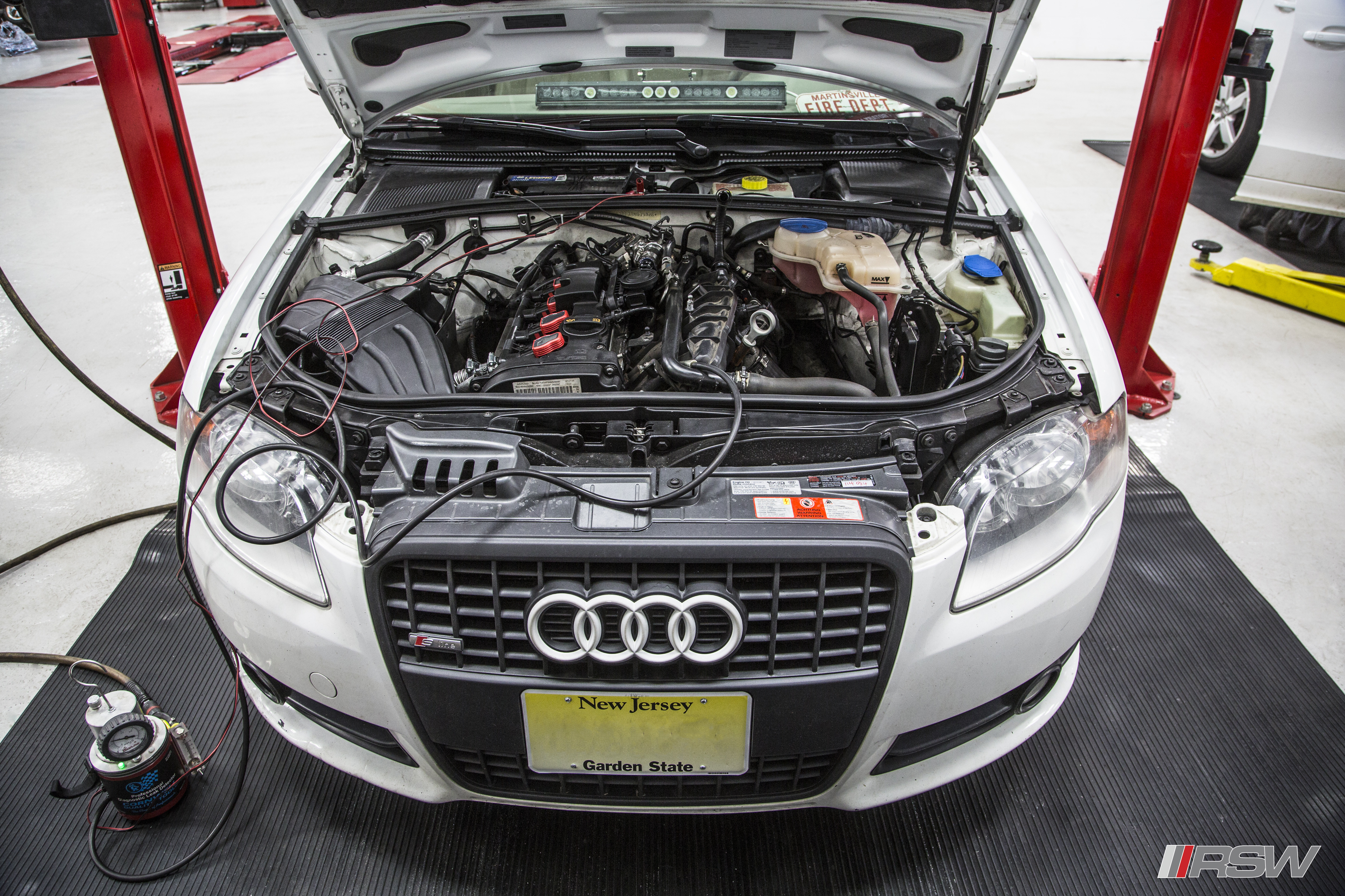 Red Audi with the hood open in the RSW Euro shop