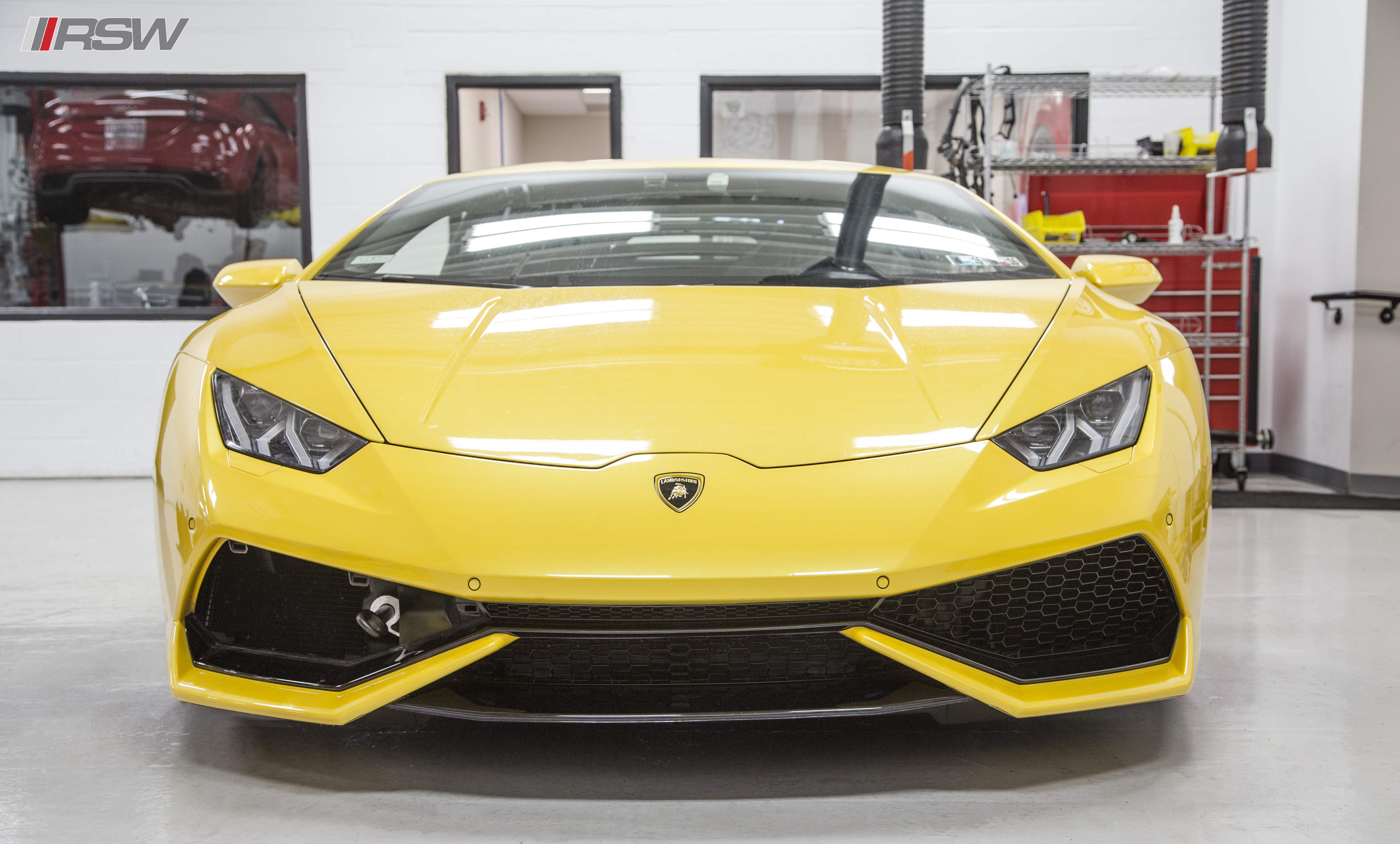 Yellow Lamborghini Huracan facing the camera in the RSW Euro shop