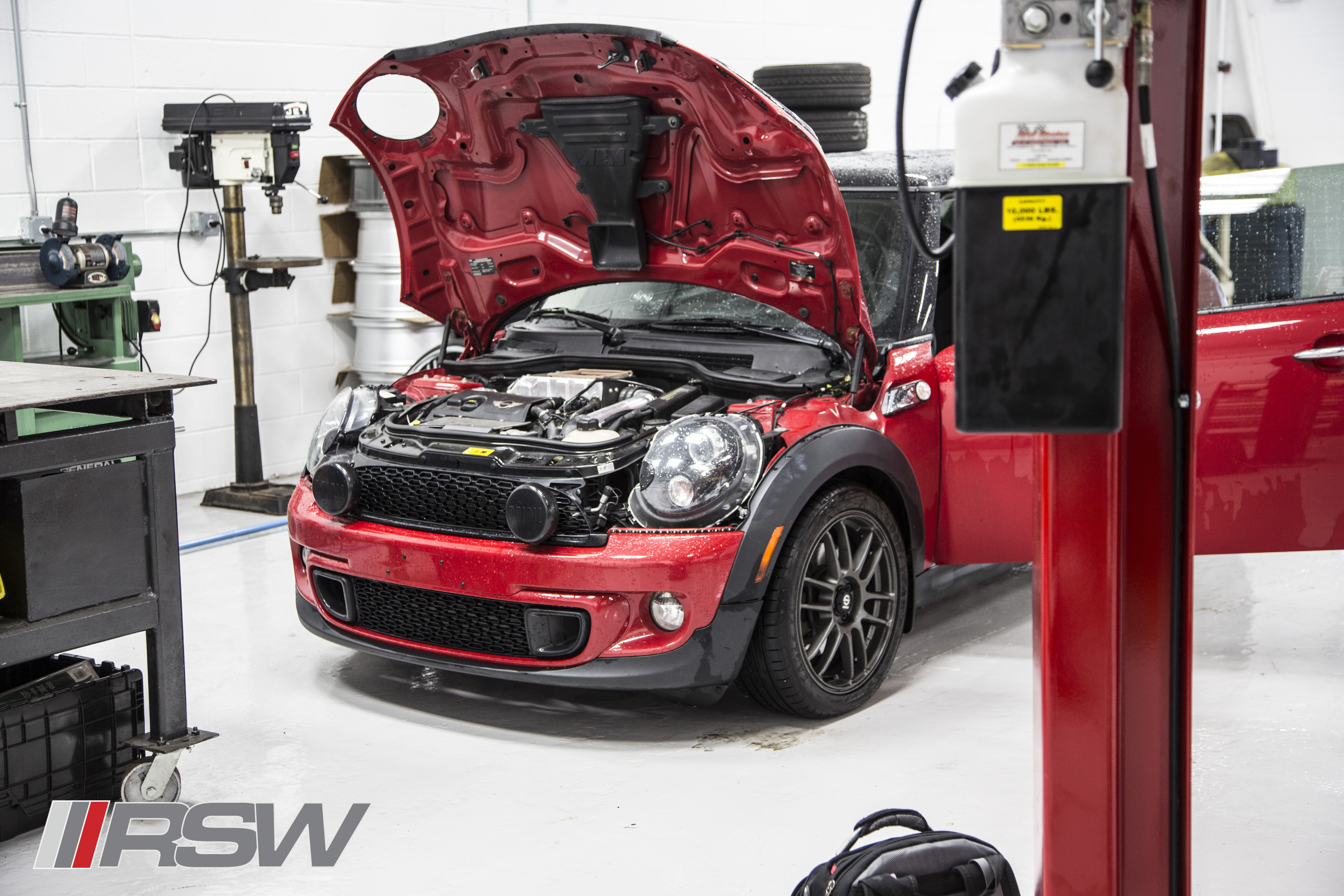 Red MINI Cooper with the hood open in the RSW Euro shop